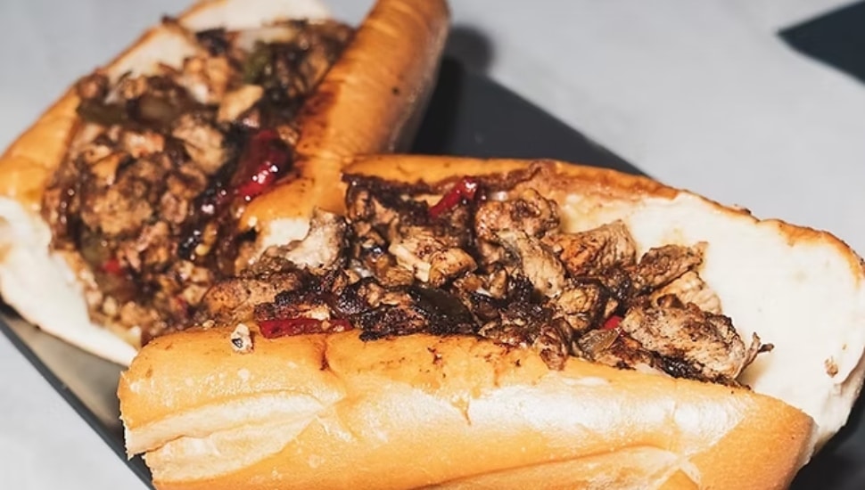 A cheesesteak with ketchup.