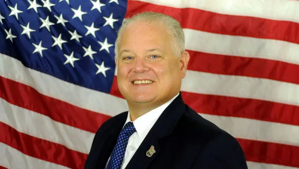 Sheriff Frederick Harran with an American flag in the background.