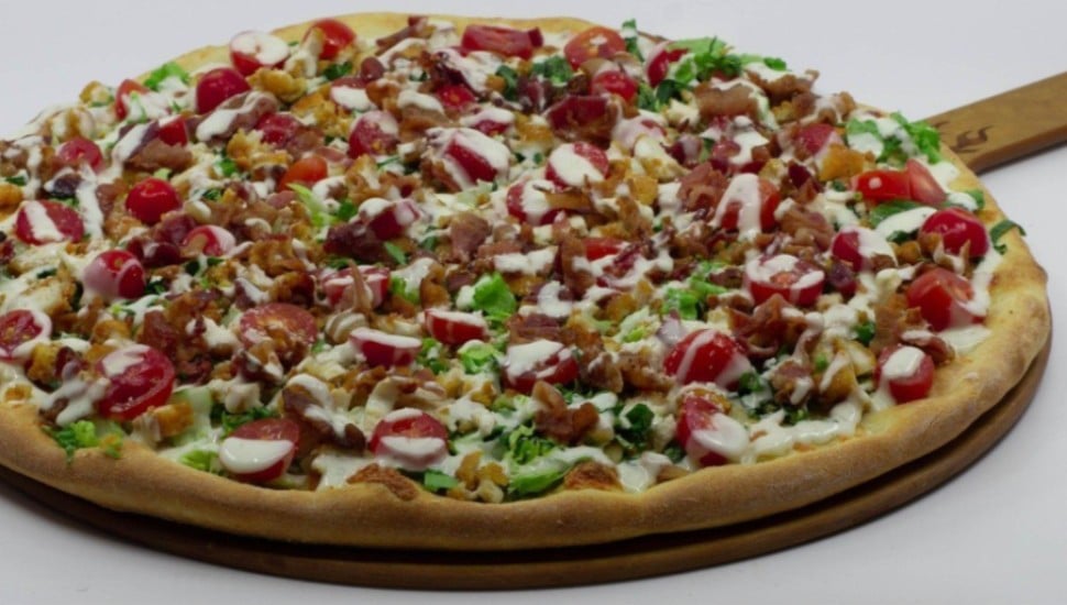 A pizza with multiple toppings made at HG Coal Fired Pizza Warrington.