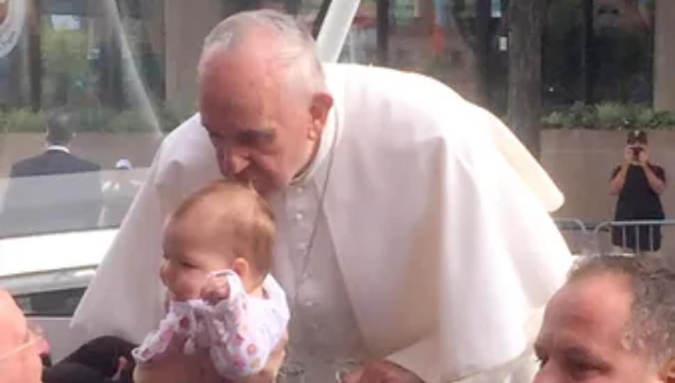 Pope Francis kisses baby Gianna Masciantonio on the head during his 2015 Philadelphia visit.