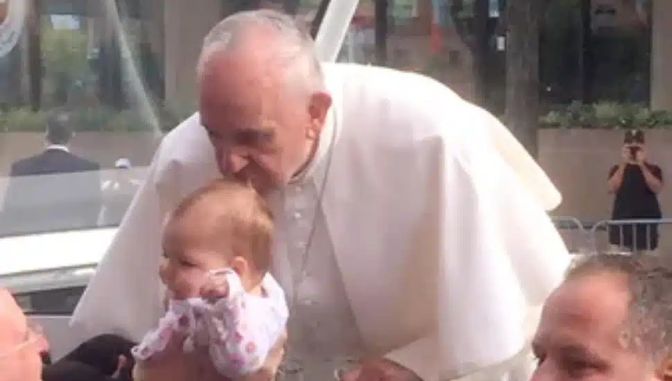 Pope Francis kisses baby Gianna Masciantonio on the head during his 2015 Philadelphia visit.