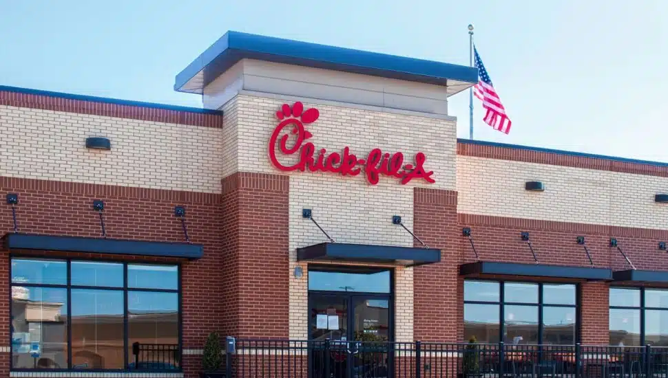 A Chick-fil-A restaurant. with an American flag.