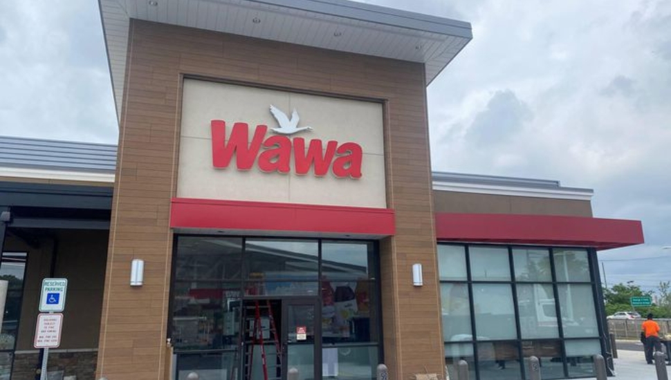 An exterior entrance and sign at a Wawa stadium store in South Philly.