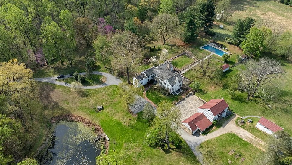 Beagle Hill Farm aerial view with green grass, structures, and pool.