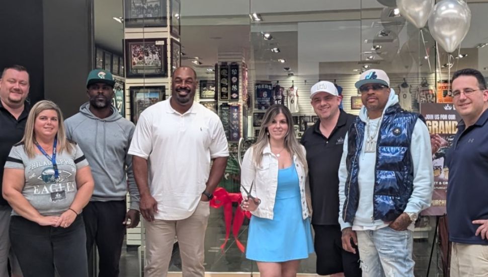 Fans pose with Donavan McNabb, Michael Vick, and Allen Iverson at the opening of Dynasty Sports at the Oxford Valley Mall.