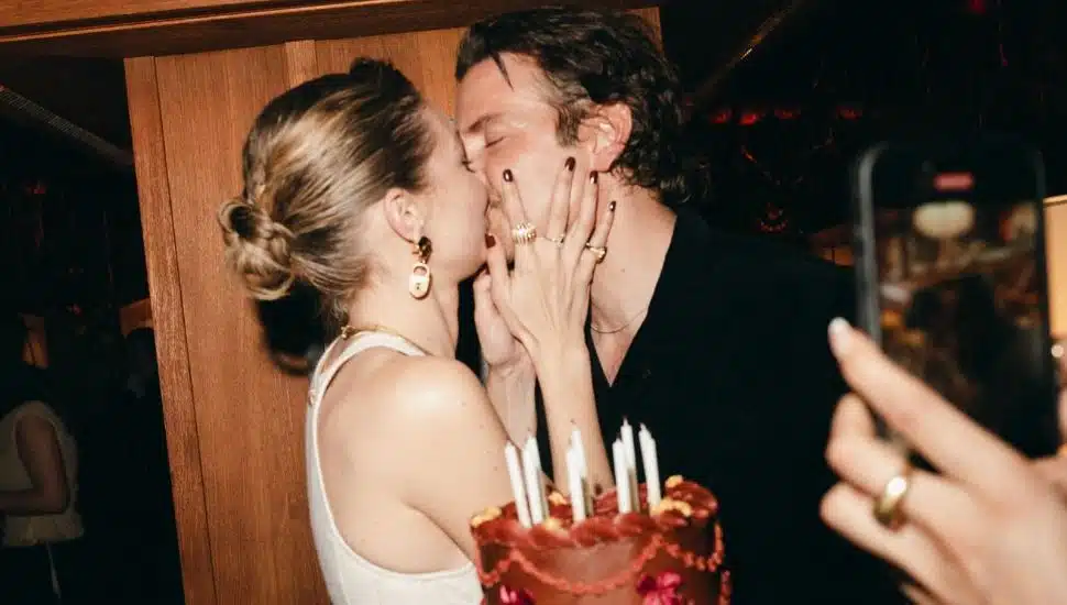 Gigi Hadid kisses boyfriend Bradley Cooper in front of her 30th birthday cake.
