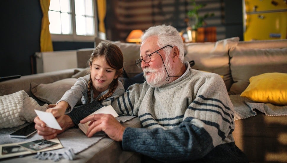 Grandad showing her granddaughter memories from past..