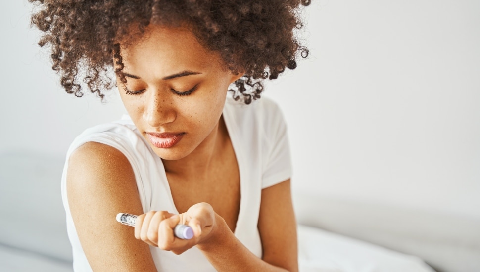 woman giving herself an insulin injection