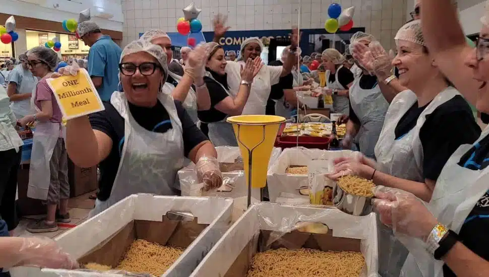 Workers at the BKO Hunger event holding up sign that says "one millionth meal."