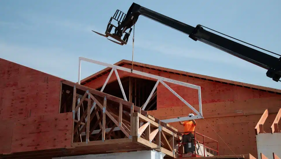 Crane lifting up the roof truss at the Bright Path Center construction site.