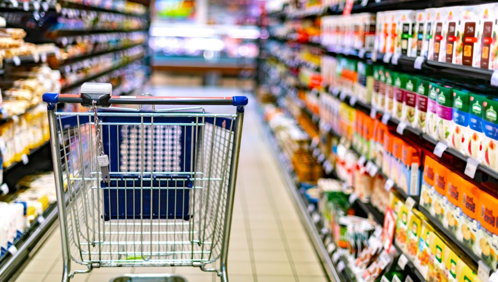 Grocery cart in a food aisle.