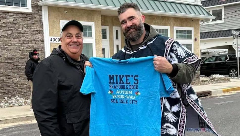 Mike Monichetti and Jason Kelce holding a shirt for the event.
