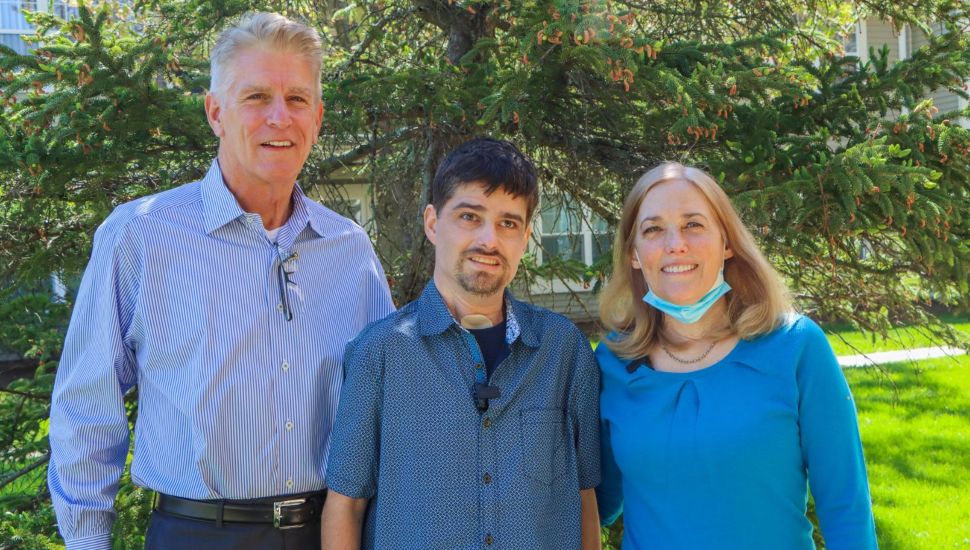 Kevin Christ and his parents standing outside.