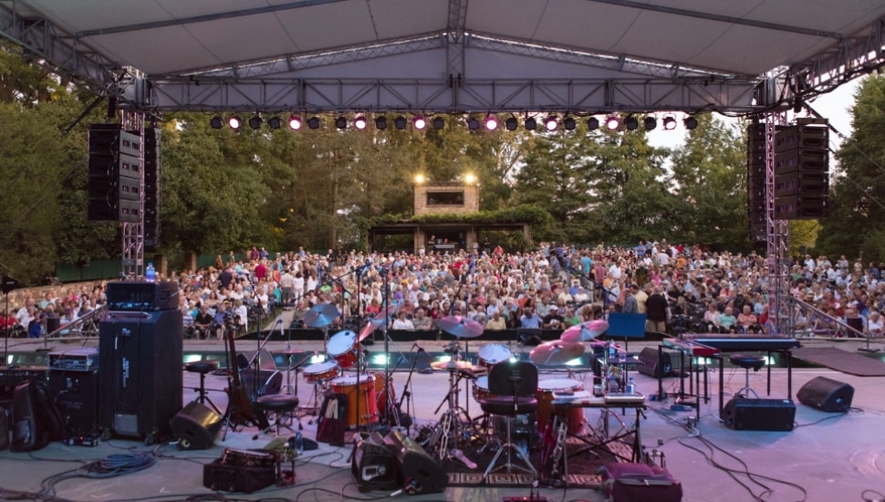 Longwood Open Air Theater with crowd of people and music playing.