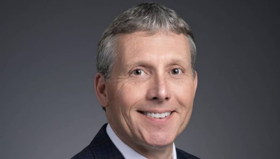 Headshot of middle-aged doctor with gray hair.