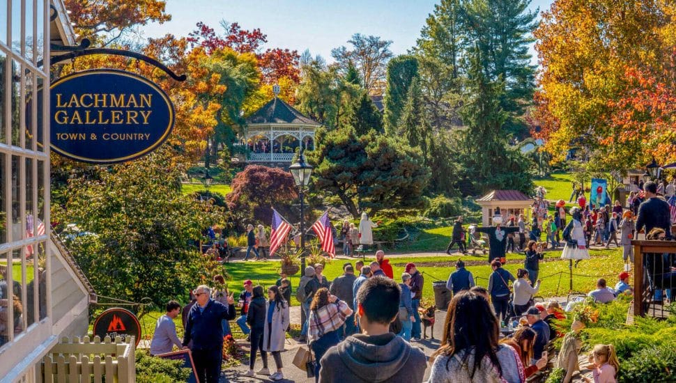 Crowd of people walking along the streets of Peddler's Village in the Fall.