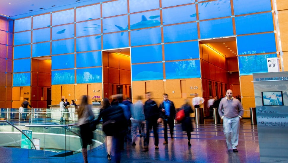 People walking inside the Comcast building.