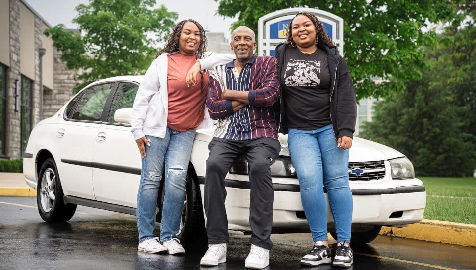 Shellman Washington III and his twin daughters, Davay and Da’Veigh, in front of their car.