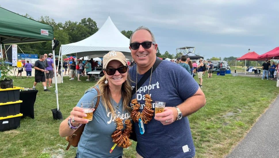 A man and woman with beer at the Upper Bucks Brewfest.
