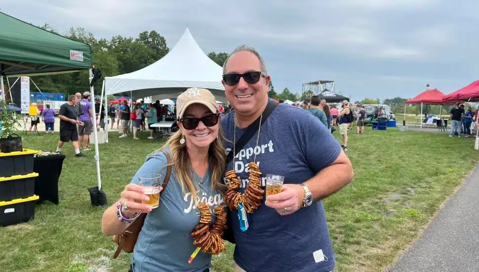 A man and woman with beer at the Upper Bucks Brewfest.