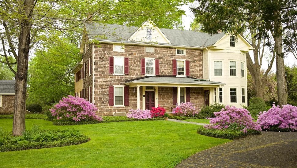 Historic Yardley home with green grass and garden.