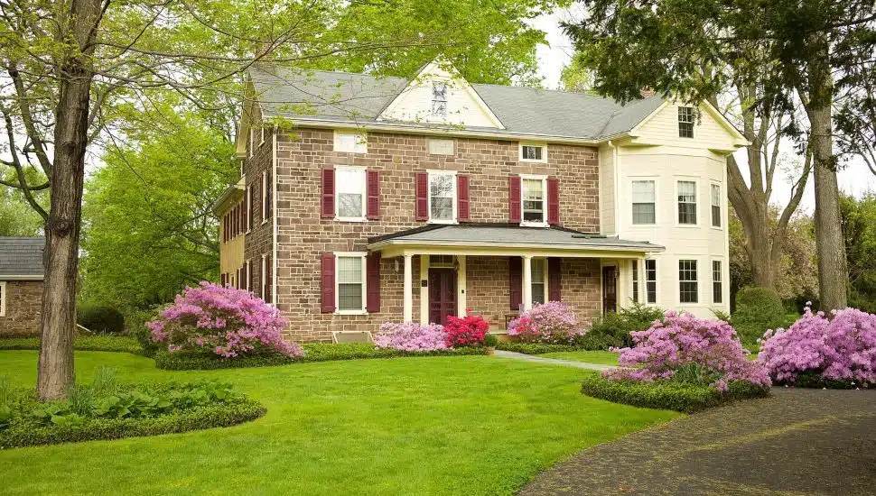 Historic Yardley home with green grass and garden.