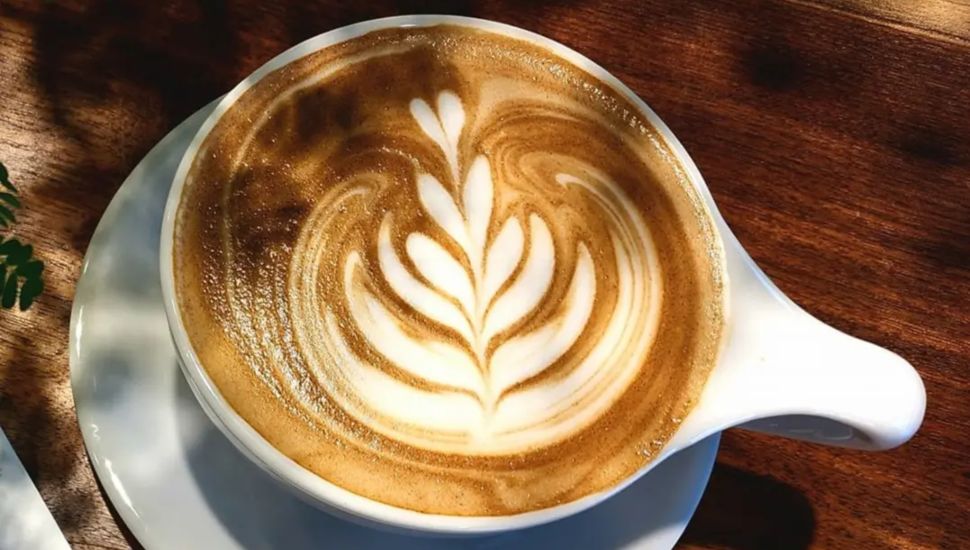 Coffee with latte art from Amsterdam Coffee Bar.