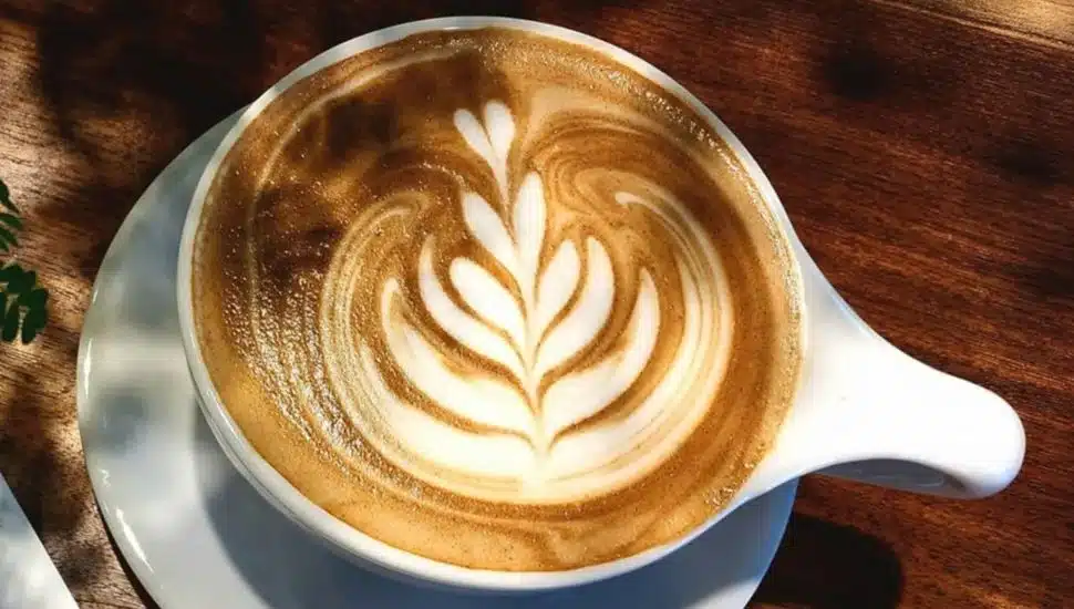 Coffee with latte art from Amsterdam Coffee Bar.
