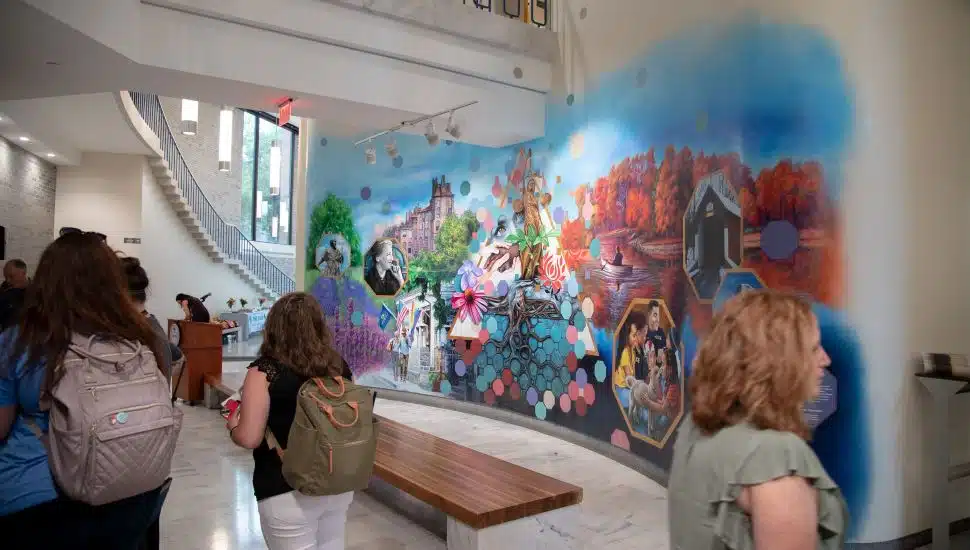 People looking at the new mural on the first floor of the County Administration Building in Doylestown.