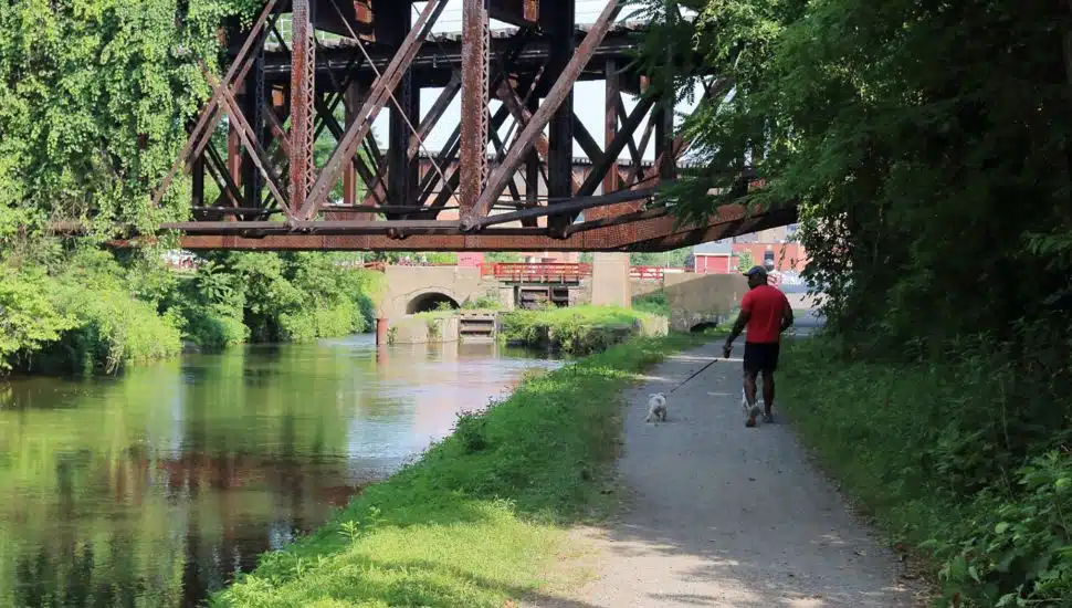 Delaware Canal State Park path under a metal bridge.