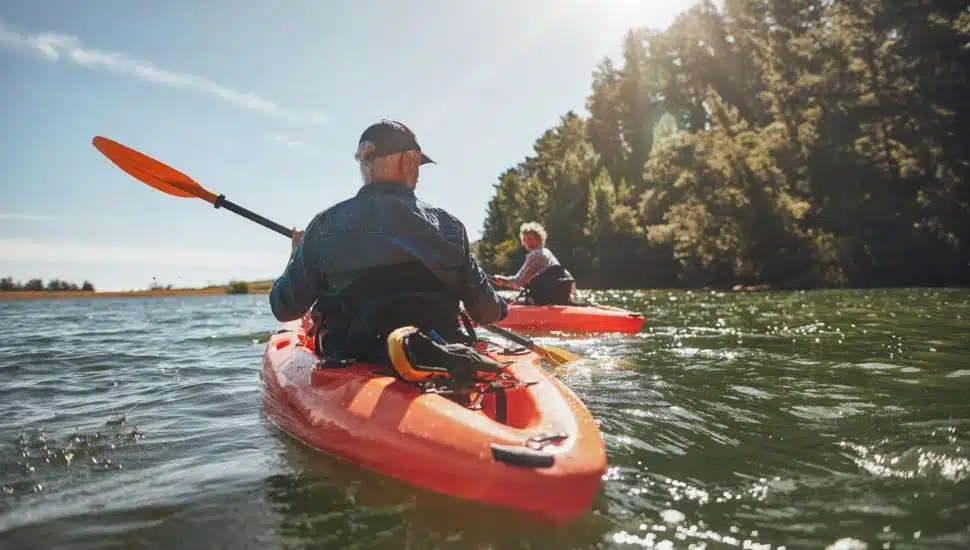 Two elderly people kayaking.