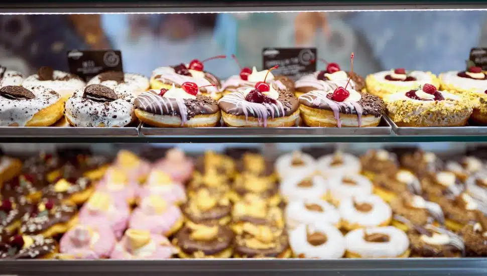 A showcase full of delicious donuts in a shop.