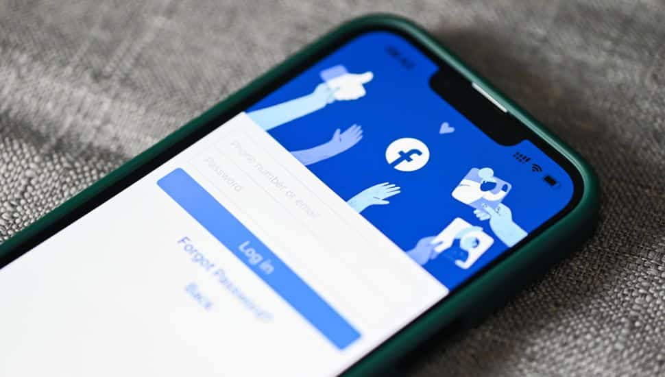 Smartphone with login home page facebook logo icon on the screen popular social media.