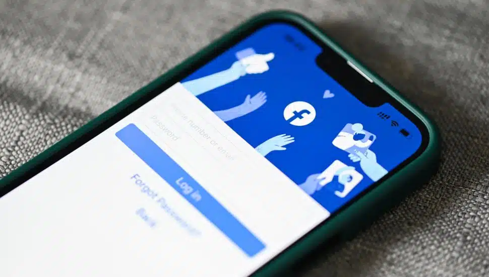 Smartphone with login home page facebook logo icon on the screen popular social media.