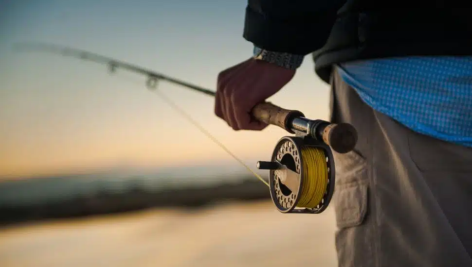 Man holding a fishing rod.