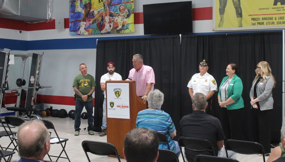 President Joe Hand speaking at conference at Joe Hand Boxing Gym announcing new program.