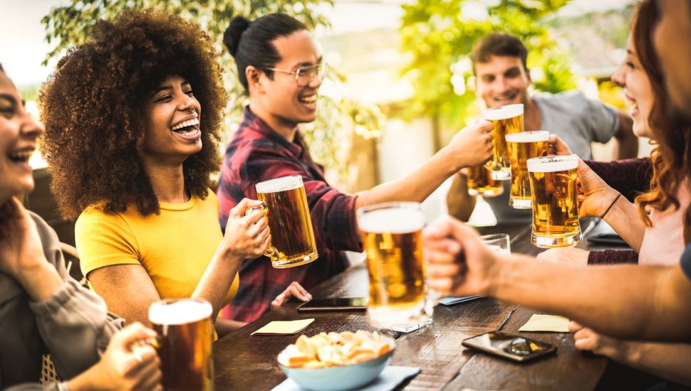Group of people enjoying beer in beer garden.