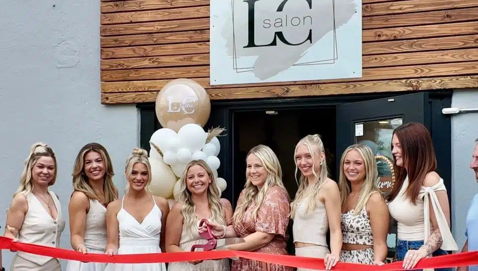 Salon LC owners and stylists cutting the ribbon at their grand opening ceremony.