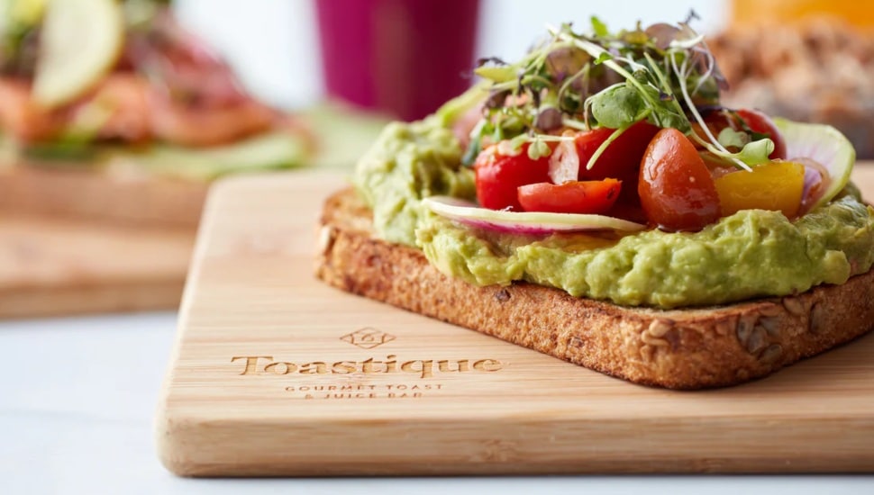 Avocado and tomatoes on slice of toast from Toastique.