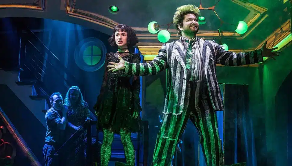 Actors playing Beetlejuice and Lydia Deetz on stage.