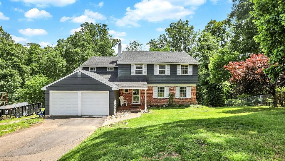 Two-story home with brick and plastic siding and a garage in Holland Bucks County.