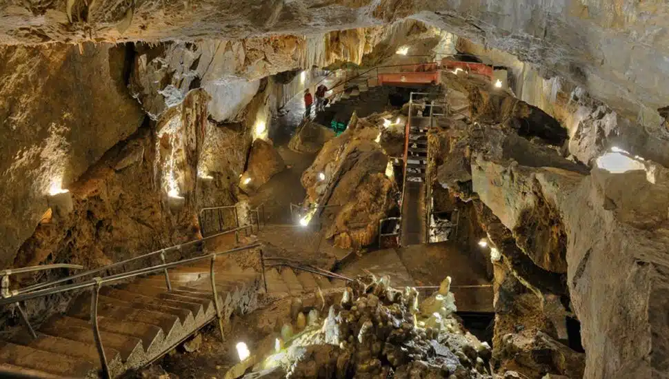 Interior of Crystal Cave with stairs leading further down into the cave.