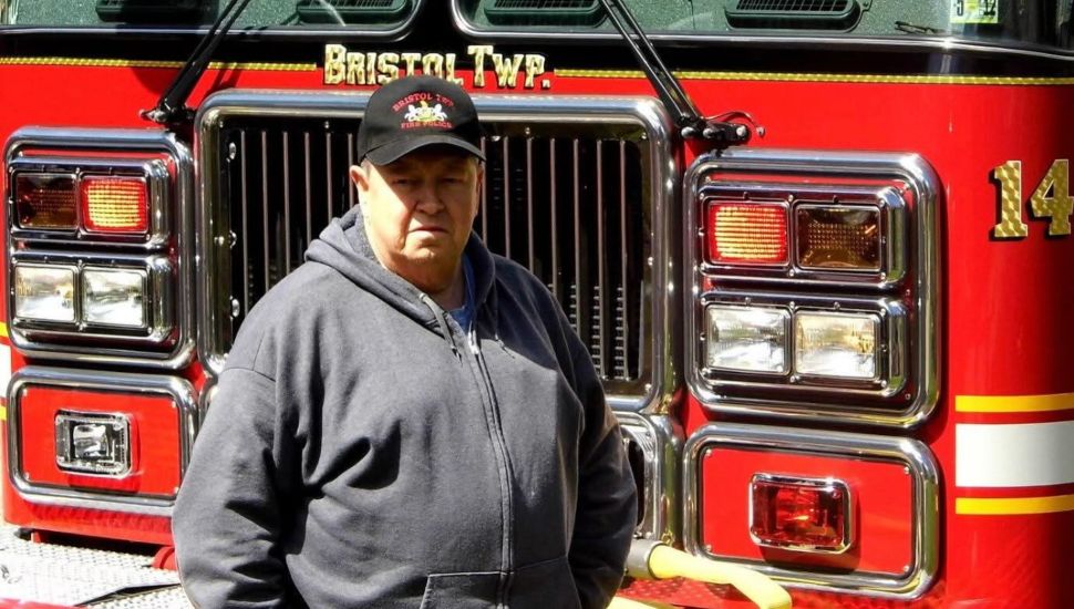Ed Margavich standing in front of a fire truck.