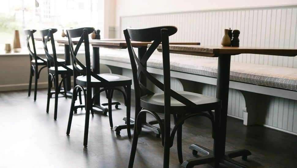 Dark wood chairs, tables and booths in Heirloom Doylestown.
