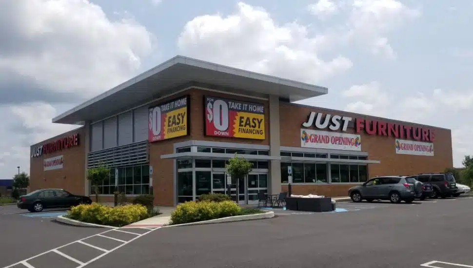 Just Furniture exterior with their grand opening banner up.
