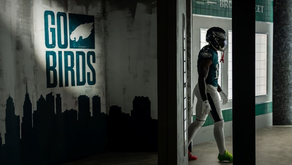 Football player walks out of locker room.