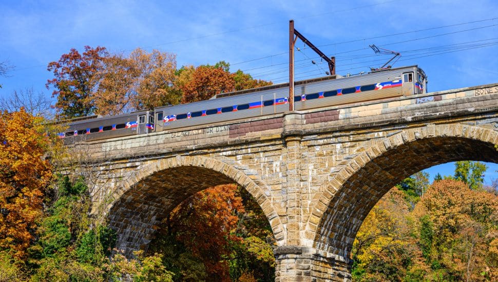 SEPTA train crossing a bridge during the fall.
