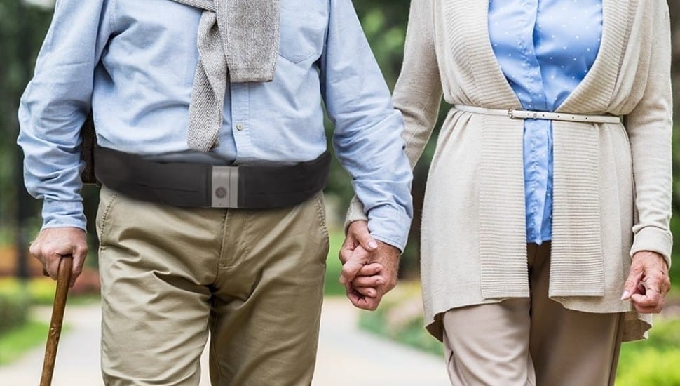 A man wearing a Tango Belt walks side by side with a woman.