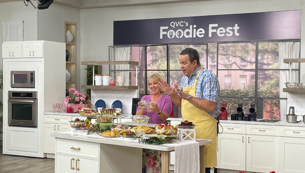 QVC hosts filming in a kitchen.