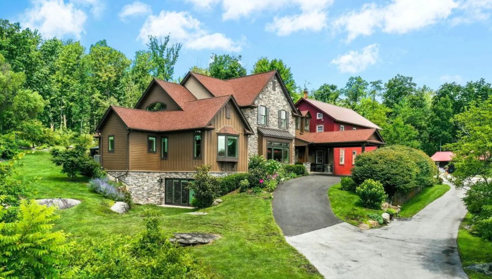 Generational compound with paved driveway surrounded by trees.